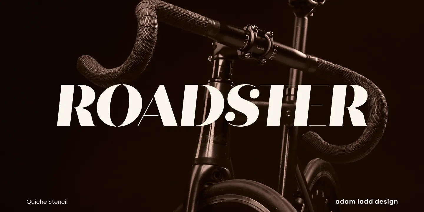 Quiche font by Adam Ladd Design — the word “ROADSTER” in a high-contrast sans-serif with stencil cutouts, overlaid on a dark image of bicycle handlebars