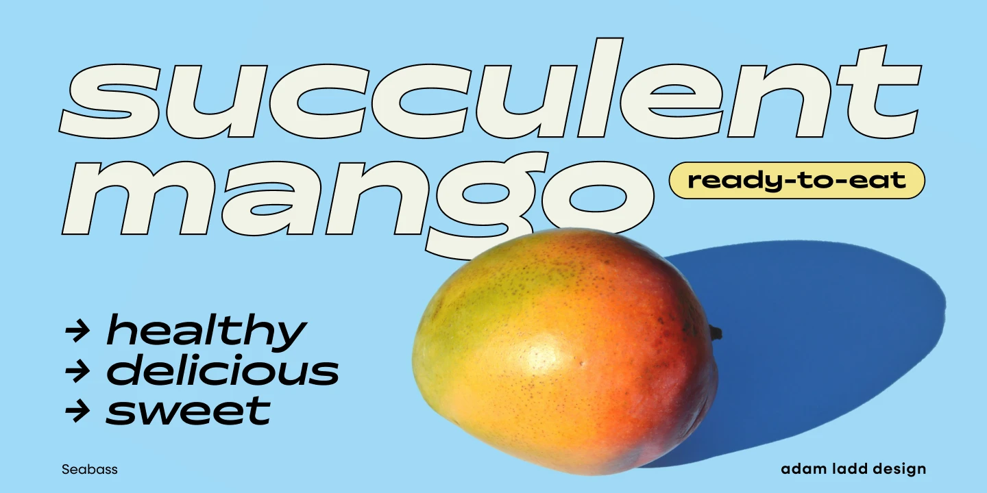 Seabass font by Adam Ladd Design — the words “succulent mango” in outlined, italic sans serif, with “ready-to-eat” in a yellow rounded rectangle, and a large mango fruit casting a shadow.